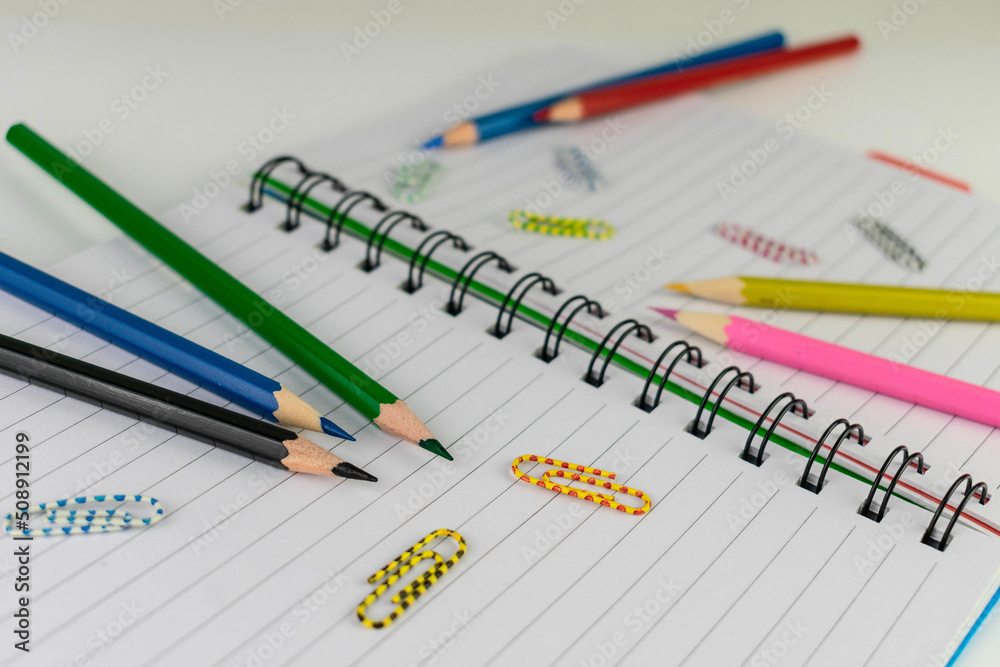 Notepad, pencils and paper clips. Back to school concept.
Notepad, pencils and paper clips. Back to school concept.