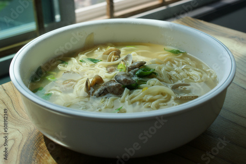 Noodle Soup with seafood is made by boiling thin noodles with seafood, such as shrimp, octopus, and clam, in a baby clam broth.