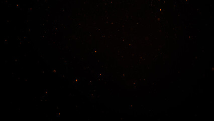 sparks like particles floating in air over black background