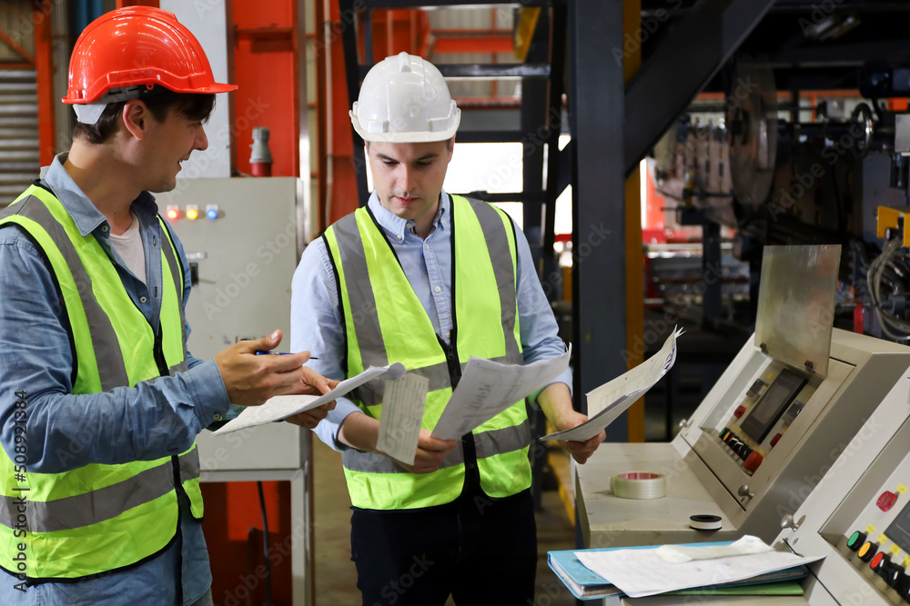 The Caucasian engineer talking and discussing in production line process after check and inspection the machine in factory, professional technician operating or work in manufacturing industrial The Caucasian engineer talking and discussing in production line process after check and inspection the machine in factory, professional technician operating or work in manufacturing industrial