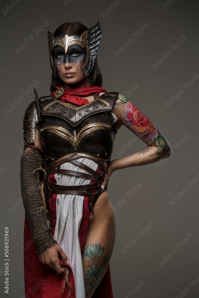Portrait of woman warrior with tattooed body from past dressed in light armor. Portrait of woman warrior with tattooed body from past dressed in light armor.