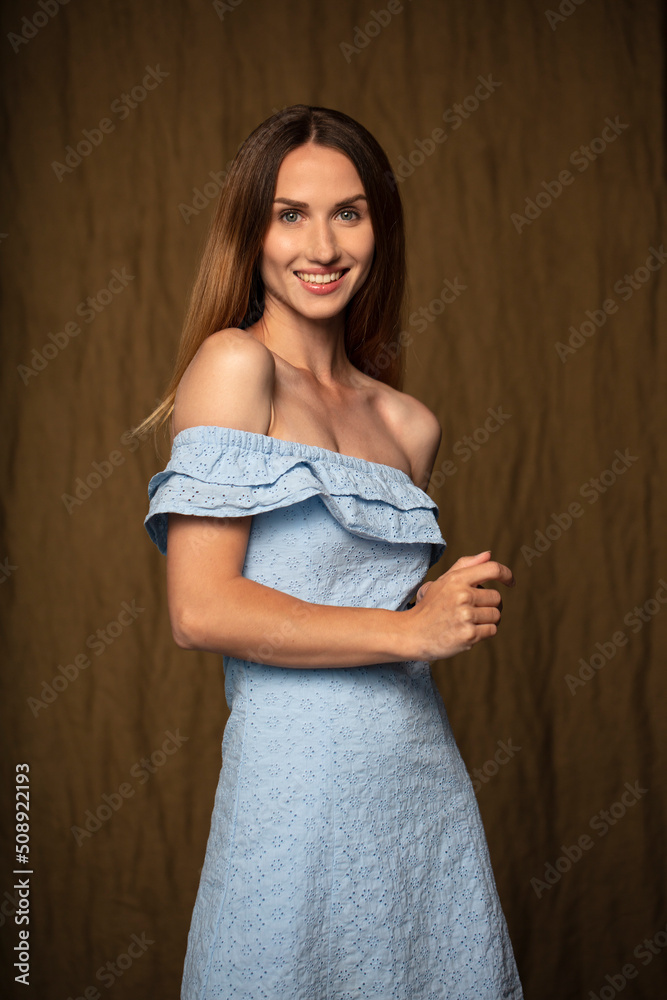 studio portrait on a dark background of a beautiful young woman