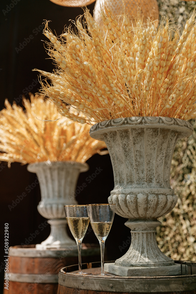 Glasses of champagne at a Ukrainian wedding with wheat decorations