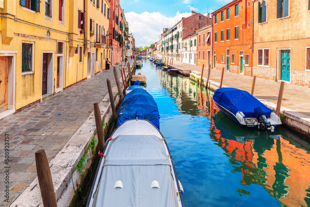 Boats moored near an italian street in the Grand Canal of Venice