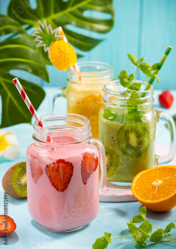 Healthy fresh fruit and berry smoothies in glass jars. Summer cold drinks