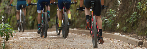Fototapeta Mountain bikers riding on bike singletrack trail, mountain bike race