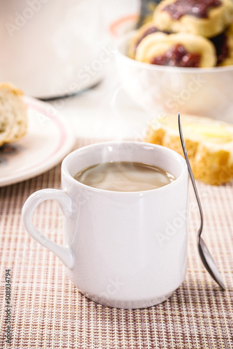 milk with coffee, traditional Brazilian breakfast drink, served hot, smoking, steaming hot, with bread and toast