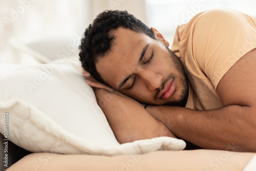 Arabic Man Napping Holding Hands Behind Head Sleeping In Bedroom