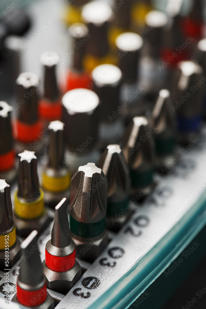 Naklejka premium A set of bits in a box in a row with a close-up repair and maintenance kit