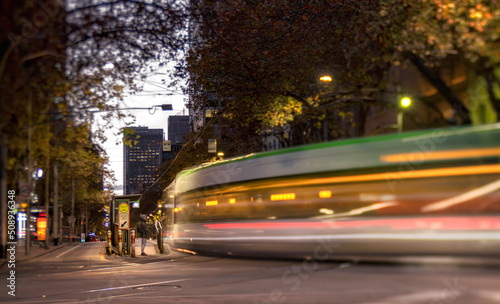 Long exposure of Melbourne tram at the intersection of Collins and Spring St at dusk