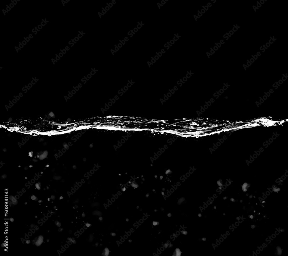 A waterline with clear water and waves on a black background. Waterline overlay effect with splashes and bubbles.