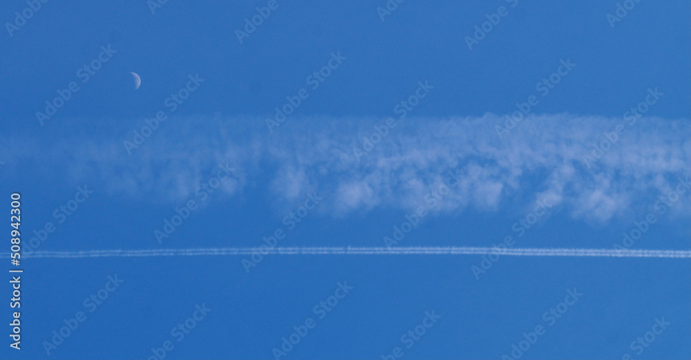 Chemical airplane contrails. Chemtrails in the sky. Airplane chemtrails in sky above Catalonia.
