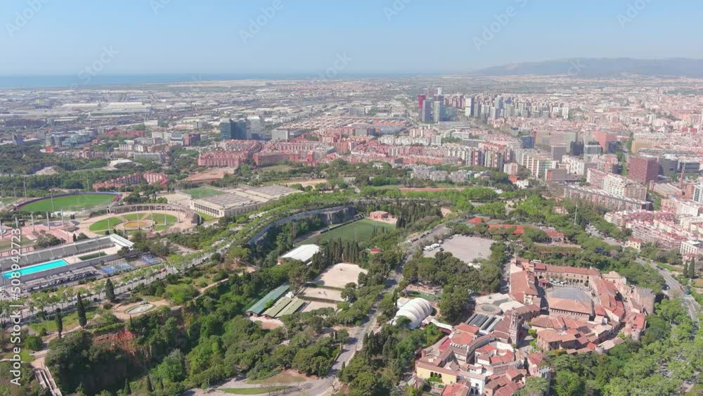 Barcelona, Spain: Aerial view of capital city of Catalonia, famous hill Montjuïc (Montjuic Mountain), sunny day - landscape panorama of Europe from above Barcelona, Spain: Aerial view of capital city of Catalonia, famous hill Montjuïc (Montjuic Mountain), sunny day - landscape panorama of Europe from above