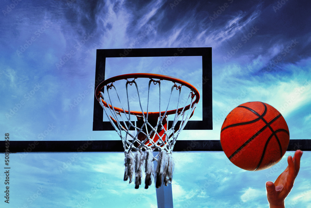 Throwing the basketball under the basket. Copy space. Throwing the basketball under the basket. Copy space.