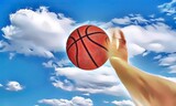 Arm of Black basketball player shooting ball