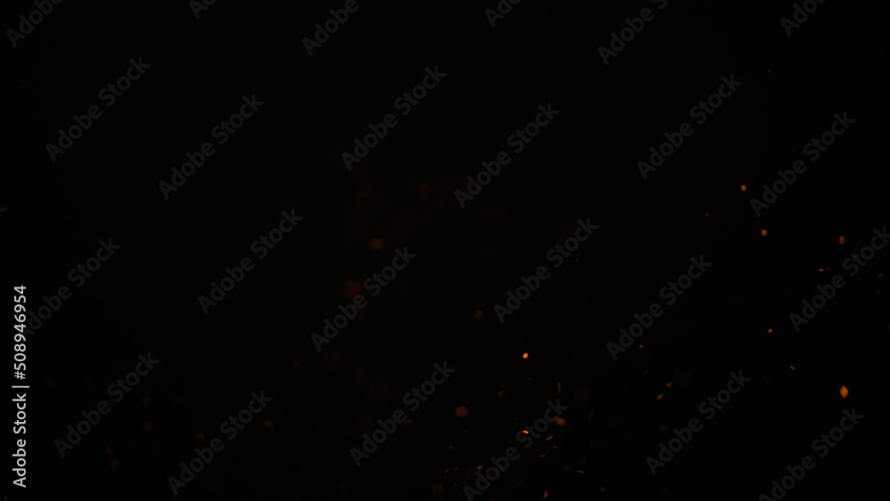 sparks like particles floating in air over black background sparks like particles floating in air over black background