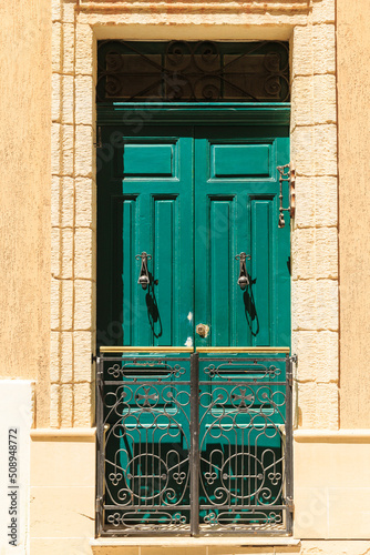 french balcony beautiful emerald color with golden wrought iron lattice