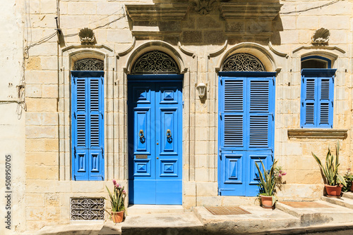 Details of mediterranean architecture. Blue doors and shutters with elegant lace