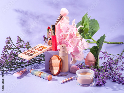 Make up products on purple geometric scene background with podium