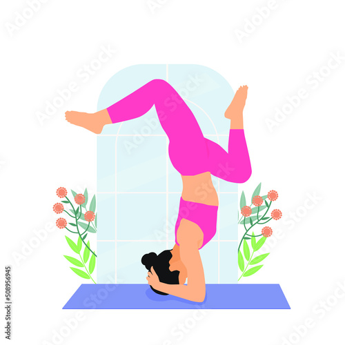 A woman doing yoga exercises, with head stand pose.