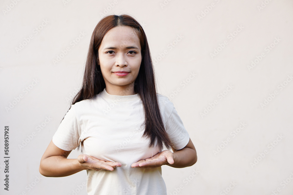 Asian woman pushing her breast with her hand Asian woman pushing her breast with her hand