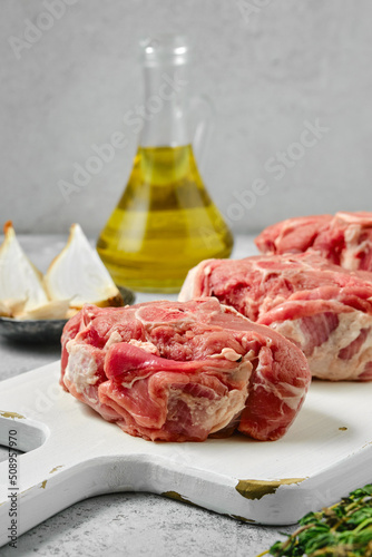 Closeup view at uncooked raw lamb loin chops saddle steaks