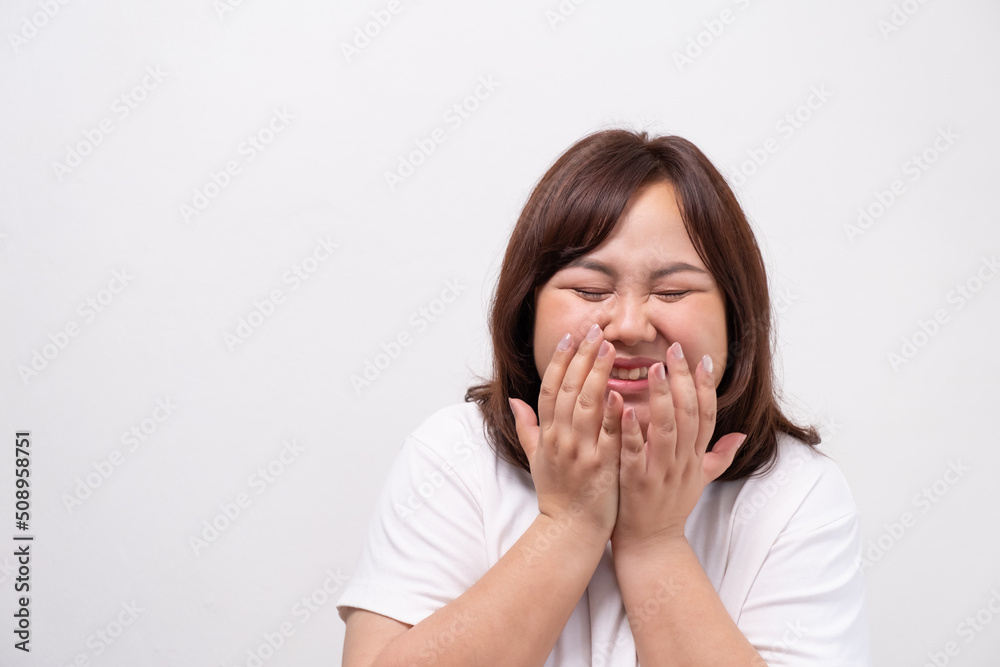 Young beautiful Asian oversize women smile with positive emotion, feeling happy and proud with her body size. Portrait shot on white background with copy space. Young beautiful Asian oversize women smile with positive emotion, feeling happy and proud with her body size. Portrait shot on white background with copy space.