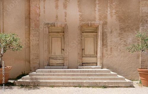Steps leading to two doors of an old building in Marseille