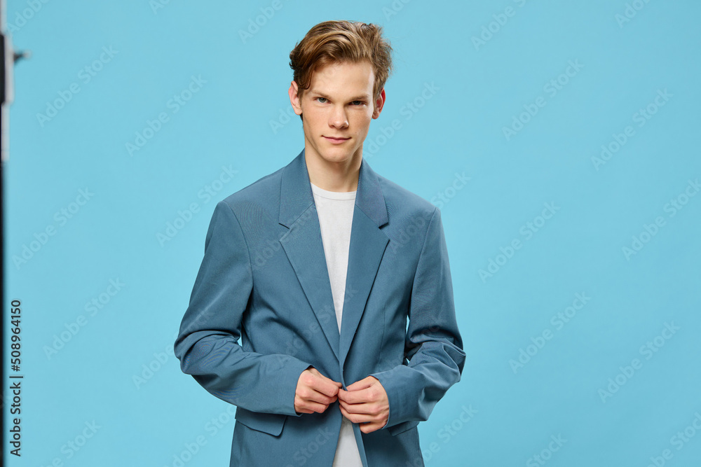 handsome young businessman buttoning up his suit