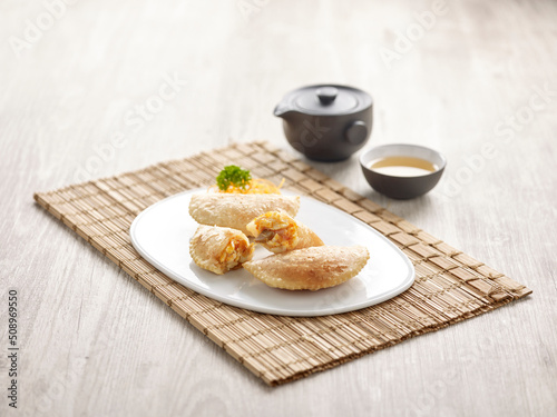 Pan-fried Chilli Crab Dumpling with sauce served in a dish isolated on mat side view on grey background photo