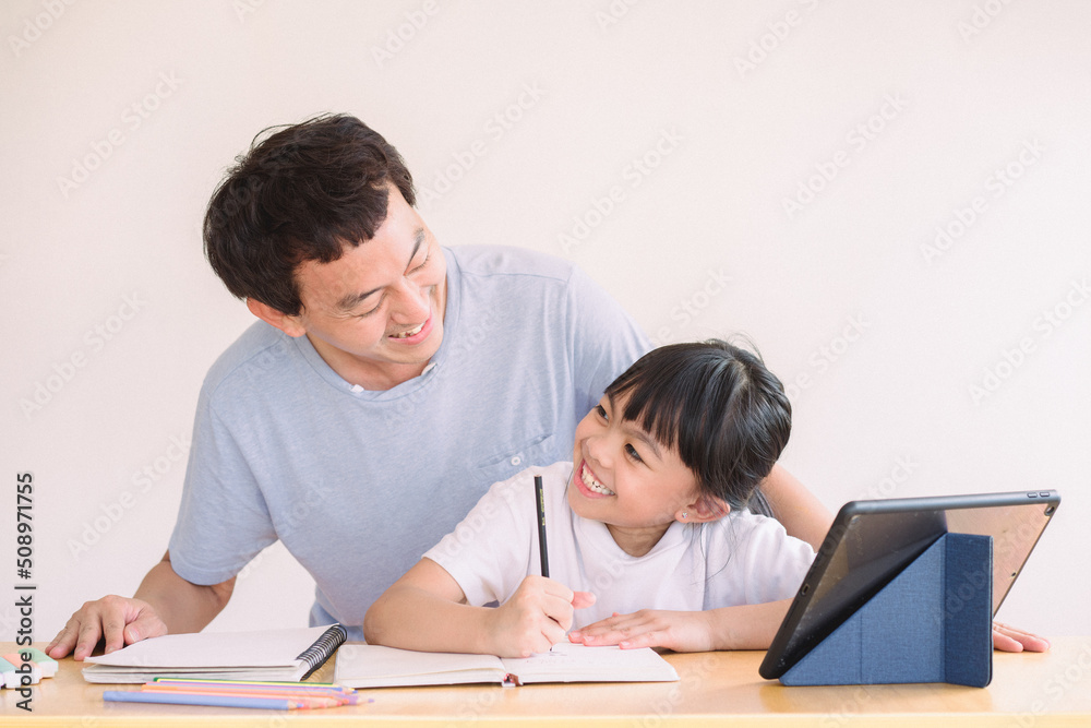 students working in classroom, Asian father and daughter using digital tablet holding mobile computer watch cartoons educational online program , Father's day, students working in classroom, Asian father and daughter using digital tablet holding mobile computer watch cartoons educational online program , Father's day,