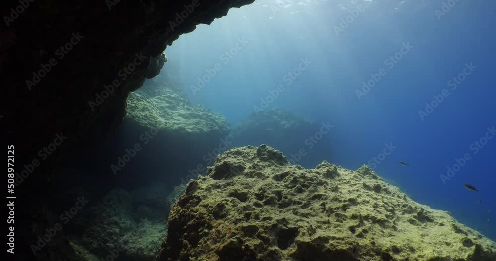 sun rays sun beams and sun shine underwater in cave beautiful light scenery in ocean scuba divers to see