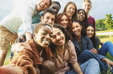 International group of authentic gen z friends selfie in the park - happy multiethnic young people cheering in the nature 