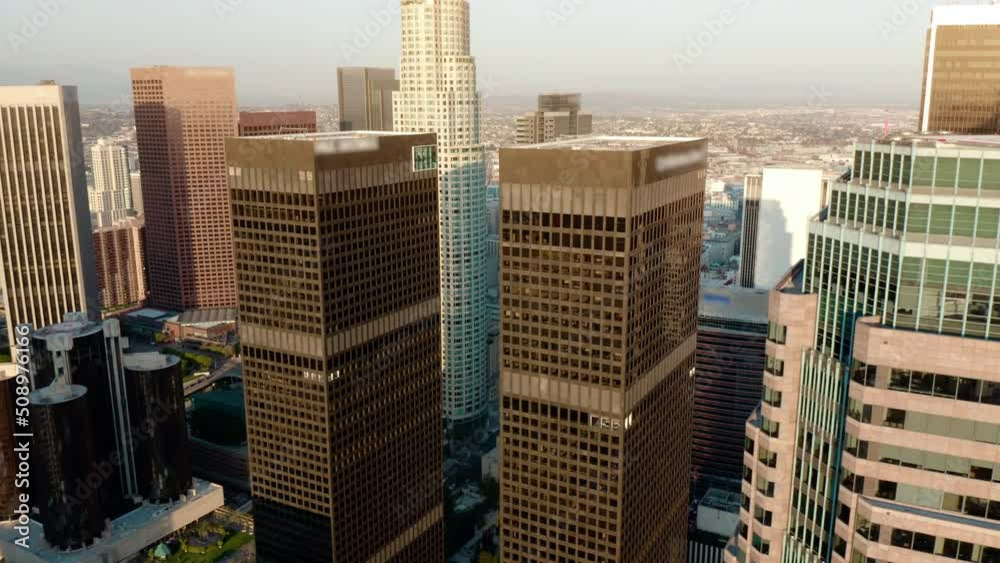 Cinematic urban aerial time lapse of downtown Los Angeles skyline.  Aerial of downtown Los Angeles in dawn, sunset in California, skyscrapers and office buildings, golden light.  Drone. 4K. 