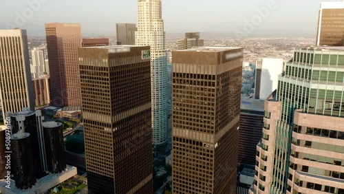 Cinematic urban aerial time lapse of downtown Los Angeles skyline.  Aerial of downtown Los Angeles in dawn, sunset in California, skyscrapers and office buildings, golden light.  Drone. 4K.  photo