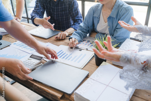 Принти на полотні Asian entrepreneur Team of small company drawing a diagram in office during team meeting discussing and analyzing the business situation new startup project in modern loft