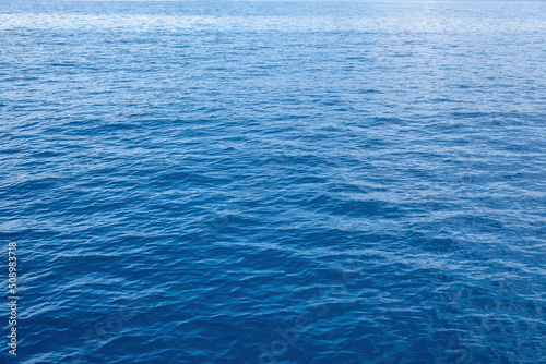 Sea water surface calm with small ripple. Ocean, deep blue color background. Aegean Sea.