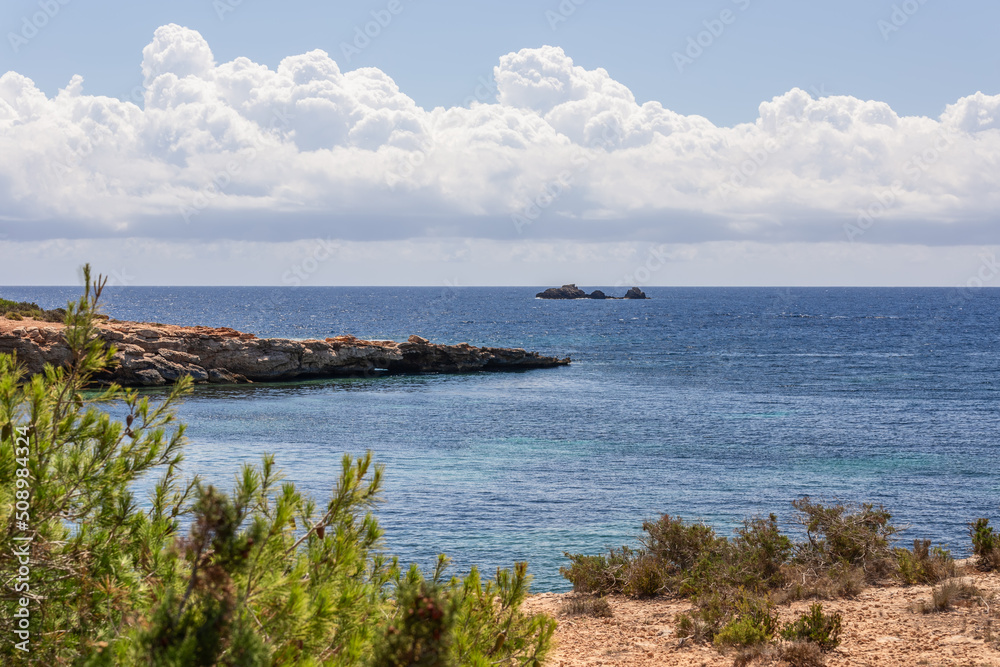 Coastline of Cala Bonita with a cape extending into the sea. Balearic Islands, Spain