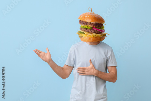 Man with tasty burger inste...