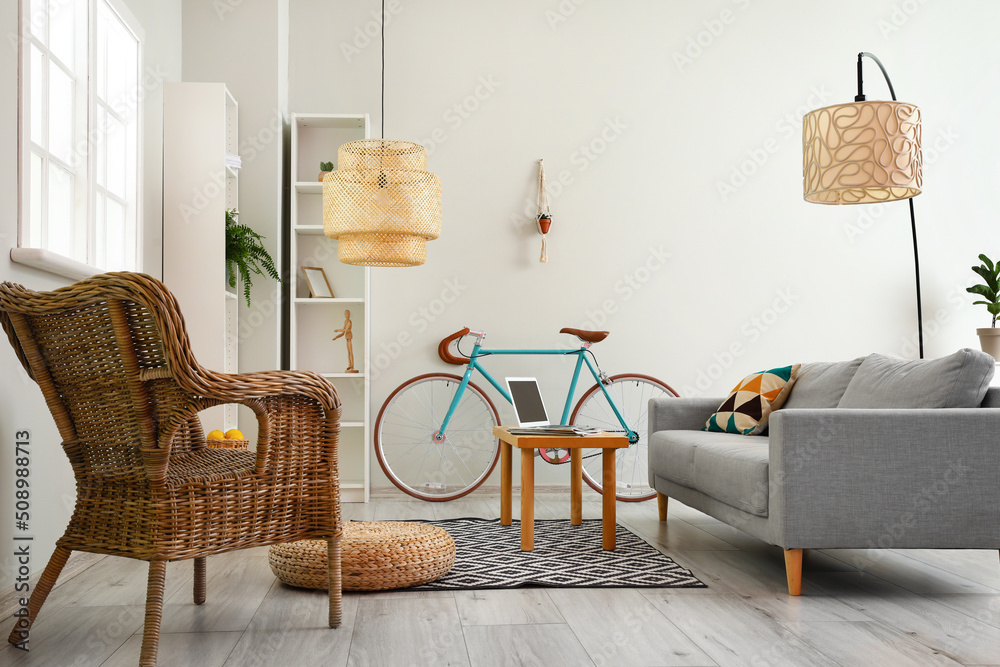 Obraz premium Interior of modern living room with comfortable sofa, bicycle and armchair