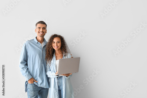 Young couple with laptop on...