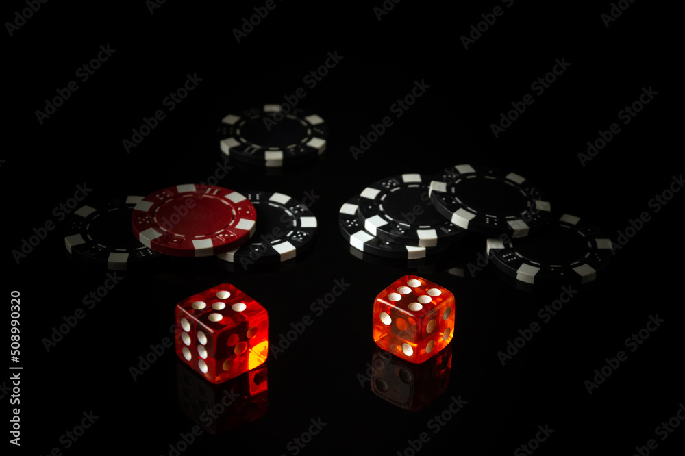 Poker dice on a black table and chips in the background. Free space for advertising Poker dice on a black table and chips in the background. Free space for advertising