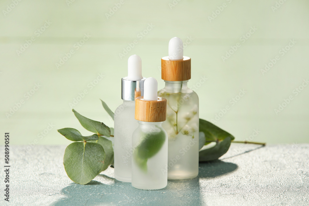 Bottles of natural serum on green table