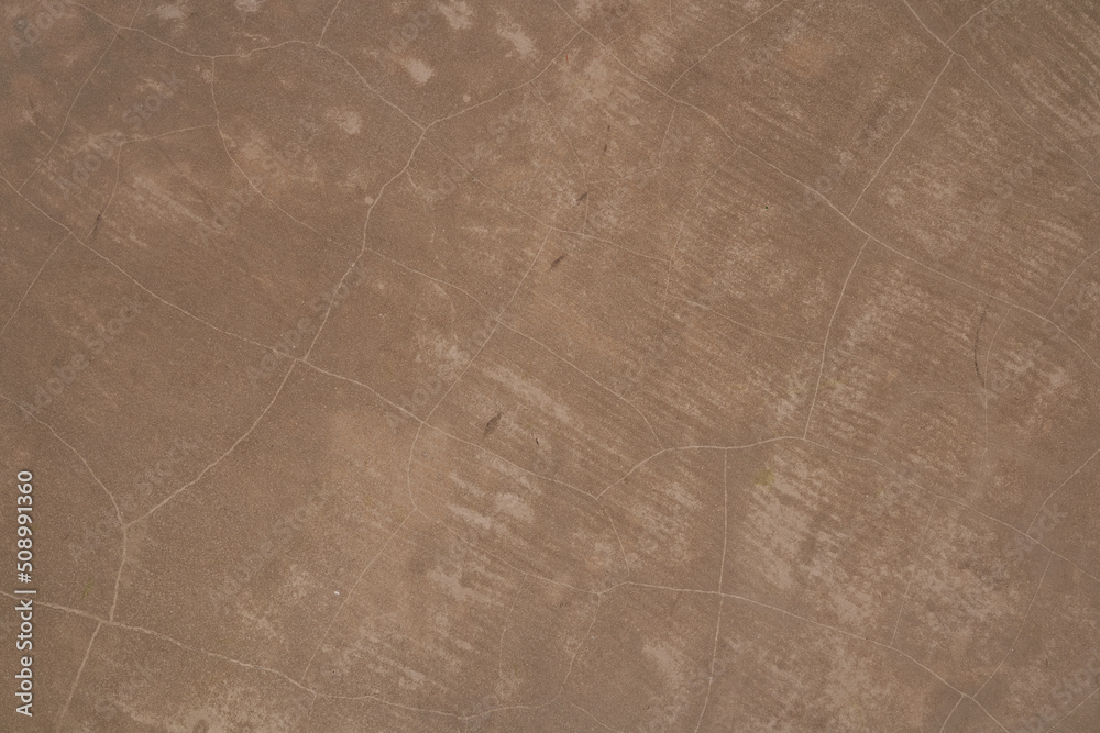 Naklejka premium Brown concrete texture. Stone wall background. Surface of the concrete old floor in scratches, which you can use as overlay in your design. High quality photo