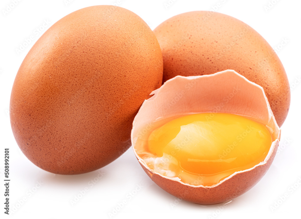 Brown chicken eggs and egg yolk isolated on white background. Brown chicken eggs and egg yolk isolated on white background.