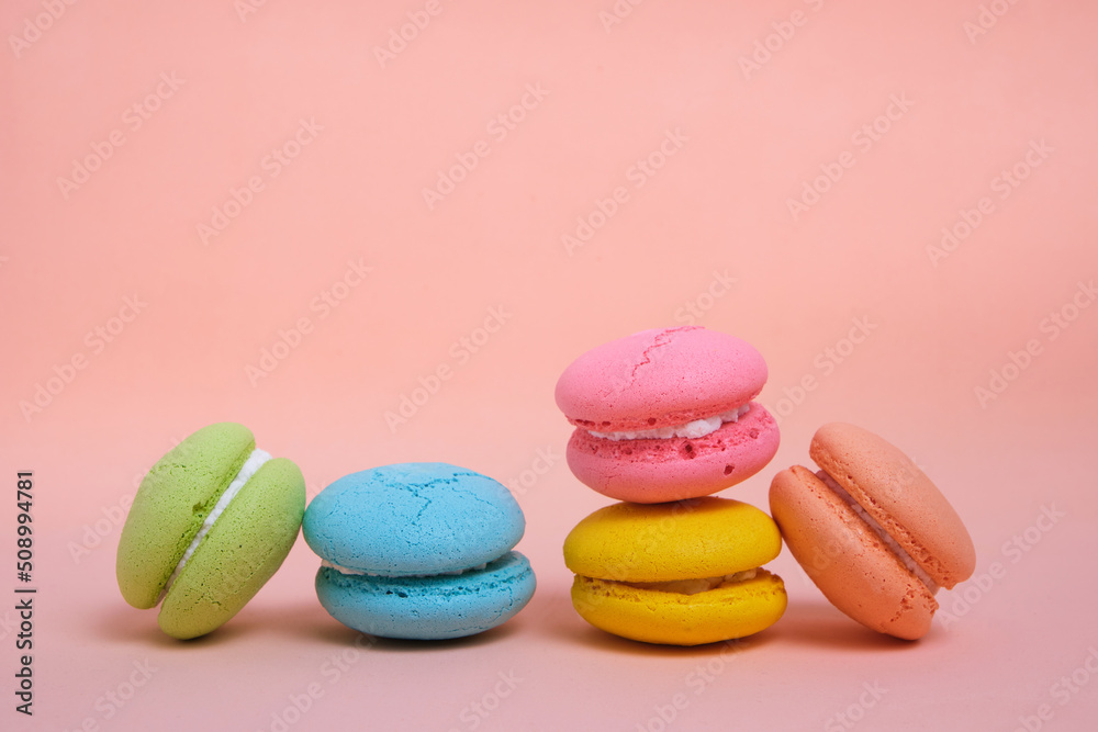 Colorful and bright French macarons cookies on pink background. Colorful and bright French macarons cookies on pink background.