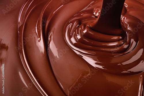 melt dark chocolate background. pouring liquid cocoa dessert