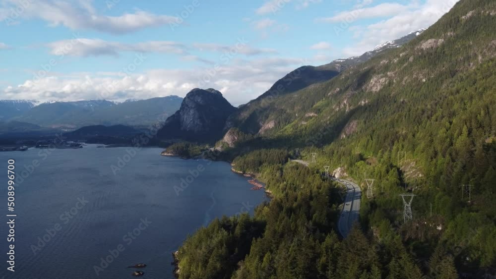 Tree-covered mountain next to a bay on a sunny day in Canada Tree-covered mountain next to a bay on a sunny day in Canada