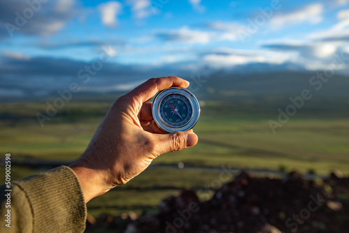 A man holding compass on hand