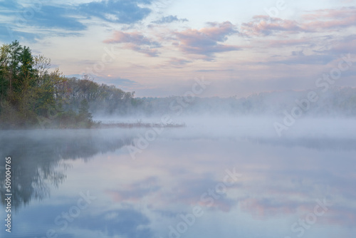 Foggy spring landscape at dawn of the shoreline of Deep Lake, Yankee Springs State Park, Michigan, USA